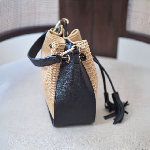 Bucket bag i raffia med svarte skinndetaljer